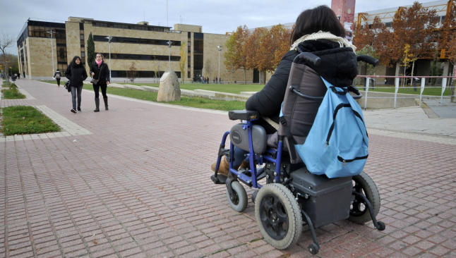Universities image presenting a women sitting in a wheelchair on a university campus